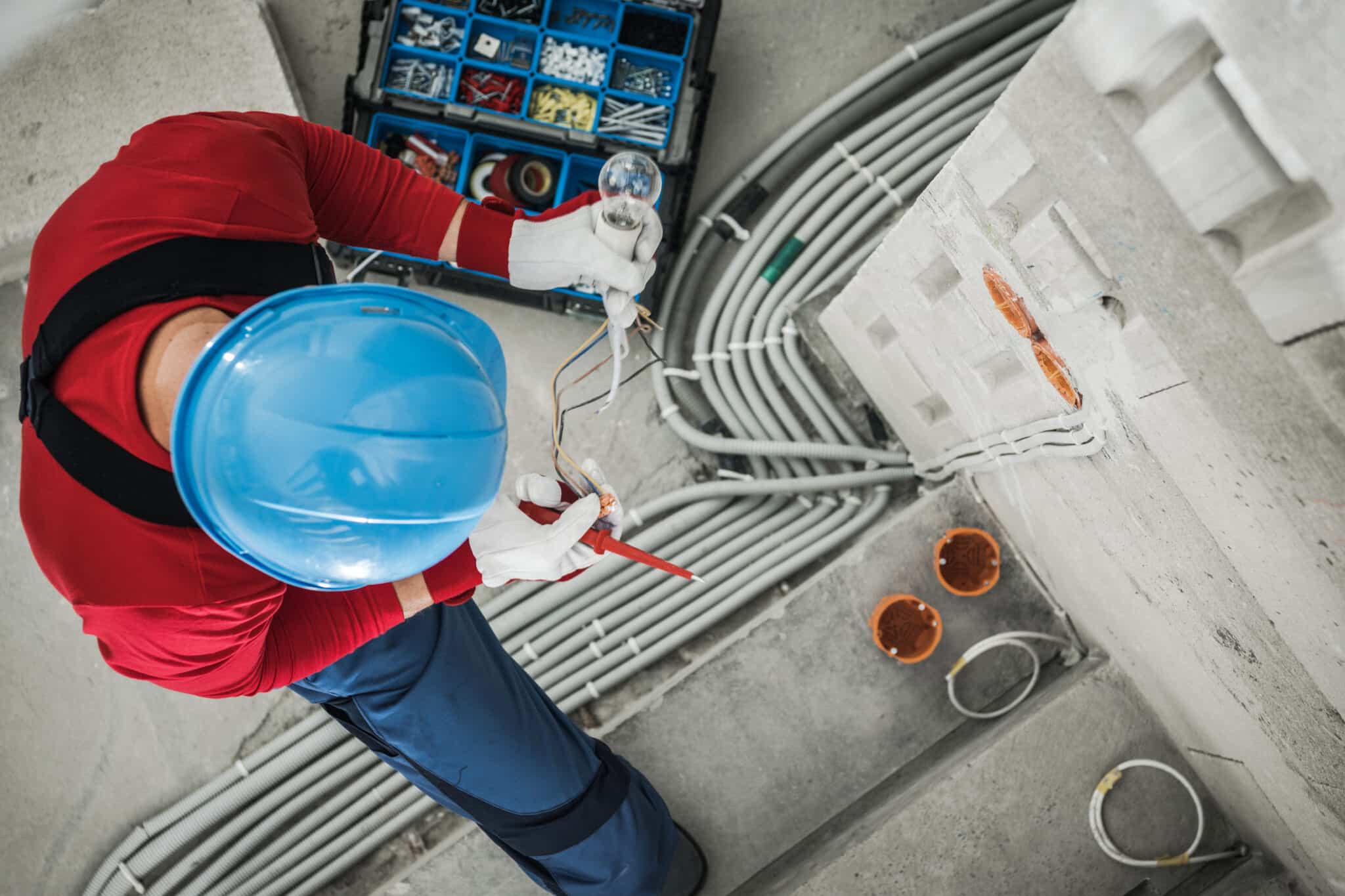 Professional electrician checking wires, Cost-Effective Electrical Solutions.
