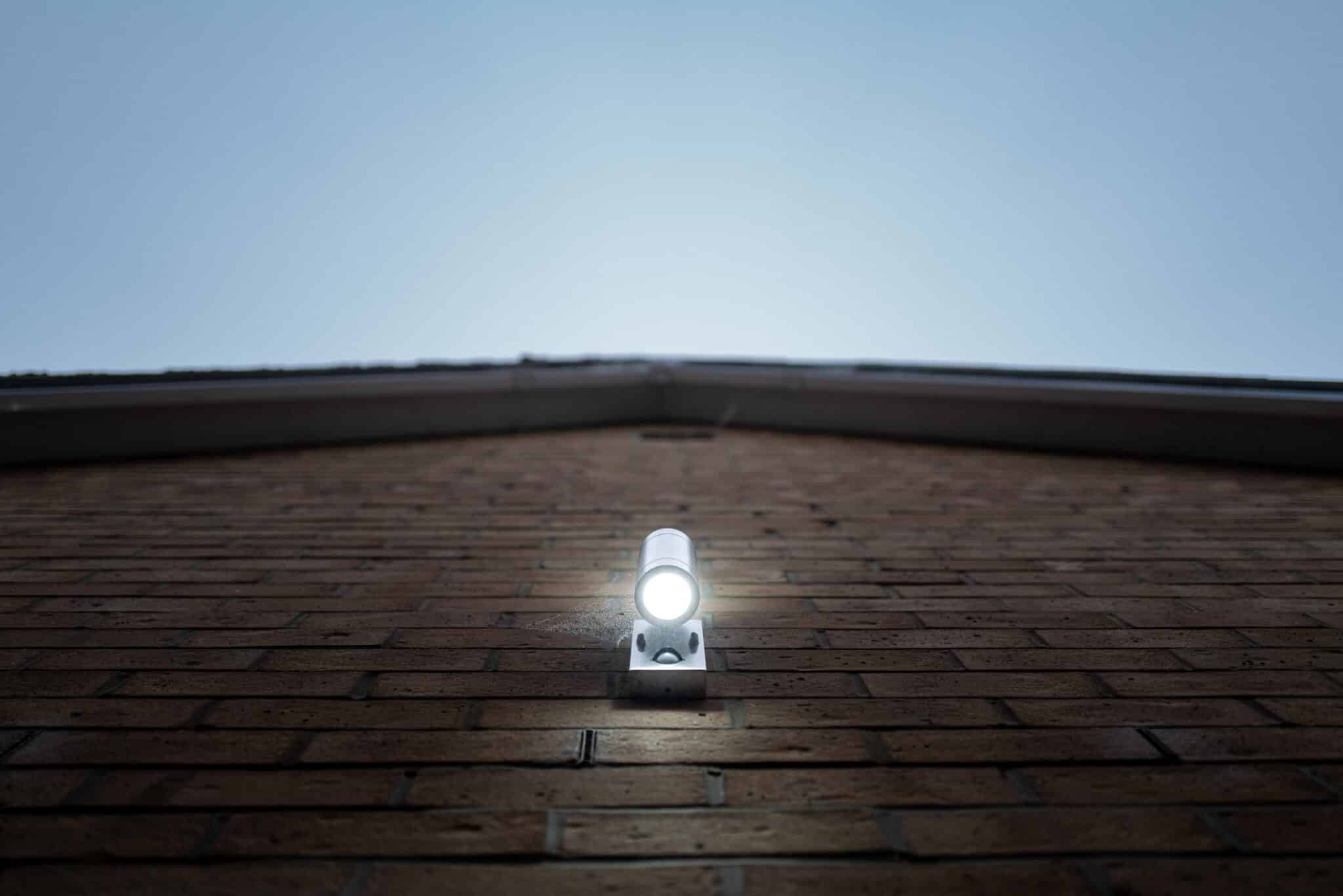 Security light seen lit on the outside of a new home, Security Lighting Options.